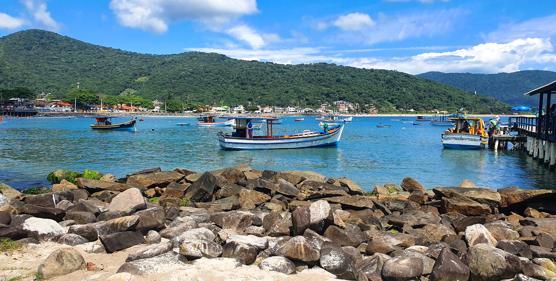 Boats float in a beautiful blue bay.